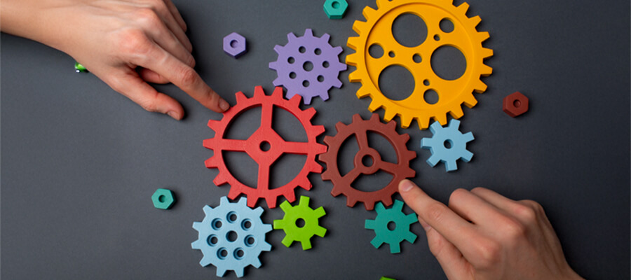 Arranging colourful cogs.