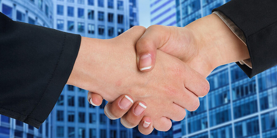 Businessman handshake on a background of skyscrapers.