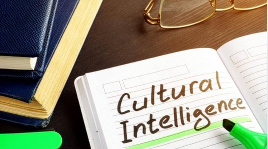Open notebook with 'Cultural Intellignce' handwwritten in black with a green highlighted underline.