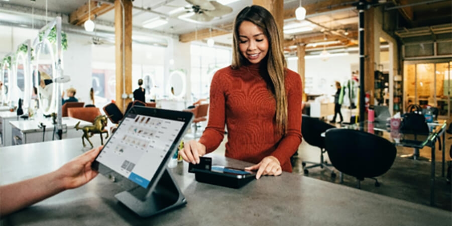 Woman paying for a product using a card.
