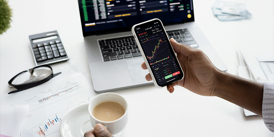 Man looking at financial data on a smart phone.