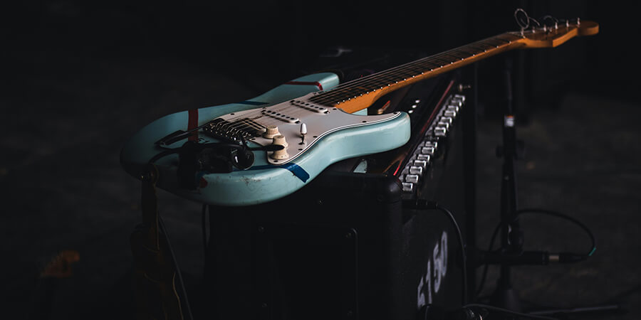 Sky blue guitar resting on top of an amp.