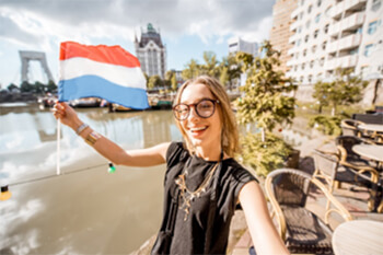 A person holding a Dutch flag.