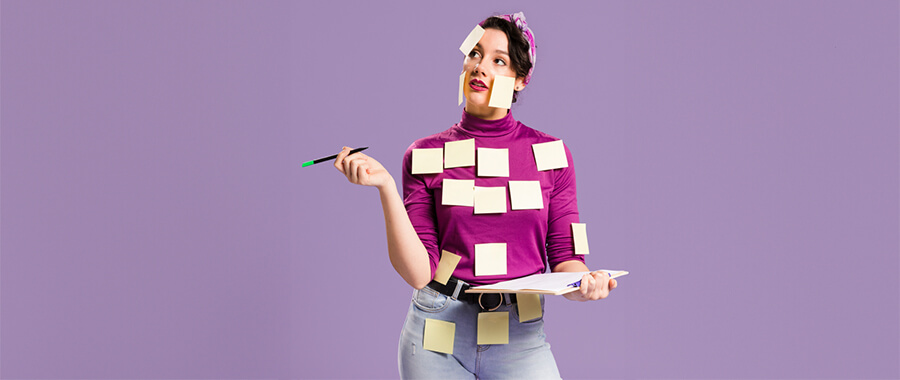 Woman with lots of PostIt notes stuck on her.