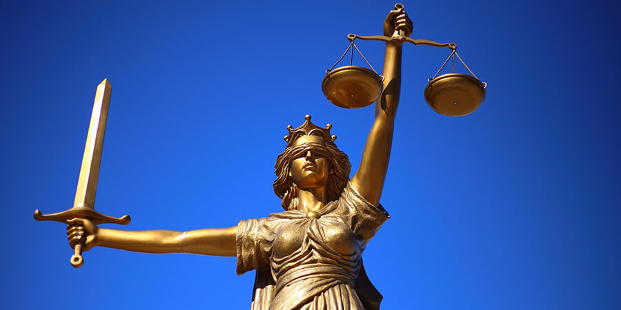 Justice statue with perfect blue sky.