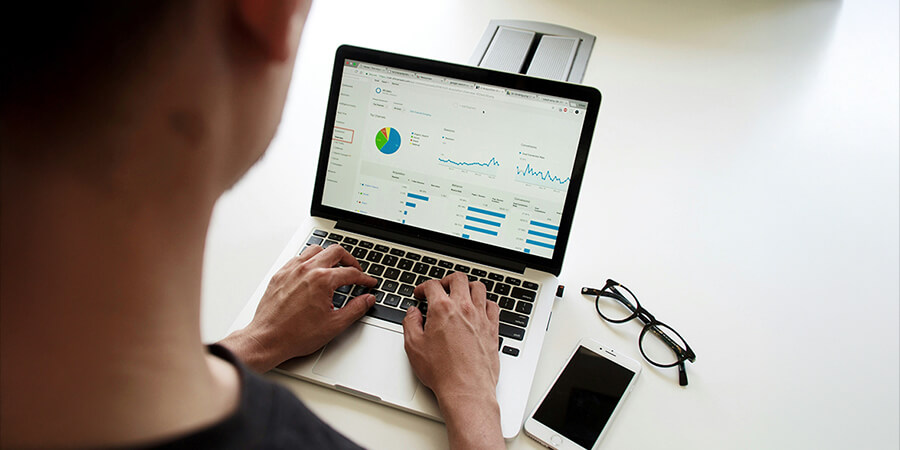 Looking at Google analytics on a laptop screen.