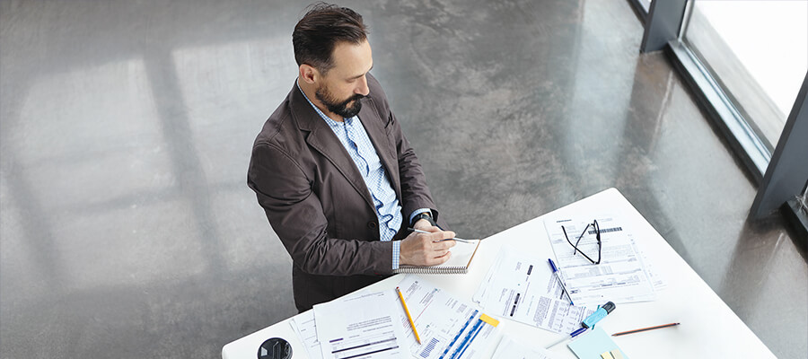 Project manager working at a desk with papers.
