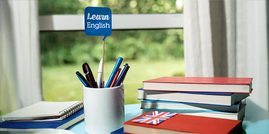 Learn English flag in a pen holder and book with Union Jack.