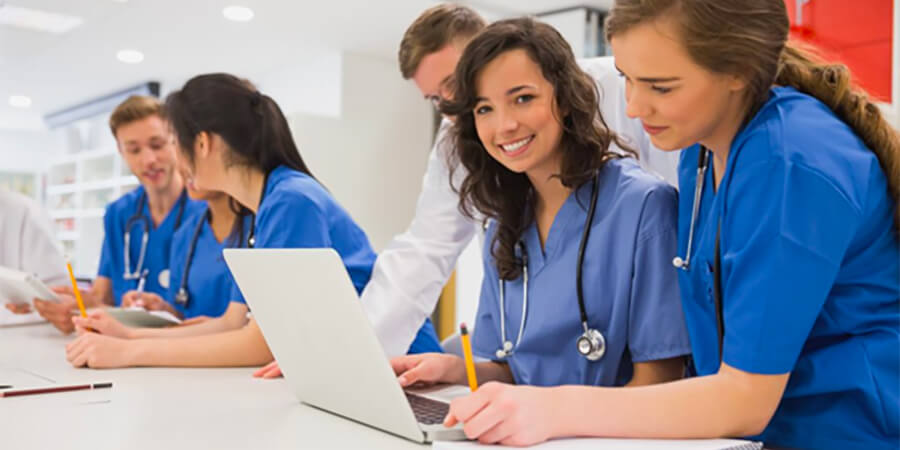Medical professionals sitting at a desk.