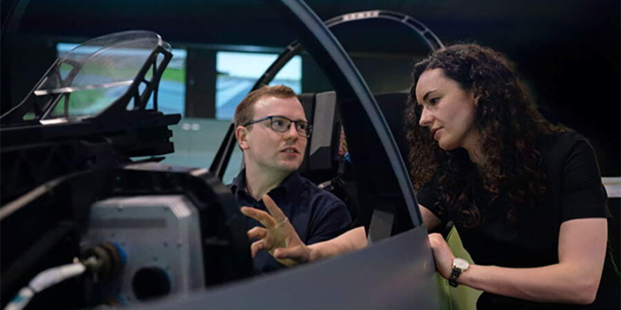 Man and woman looking at a machine.