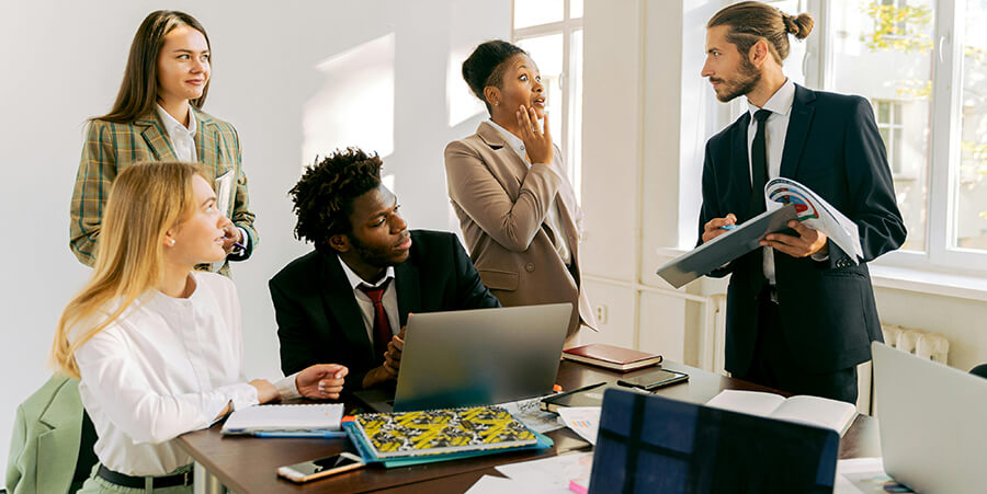 Group of people in suits in an office.