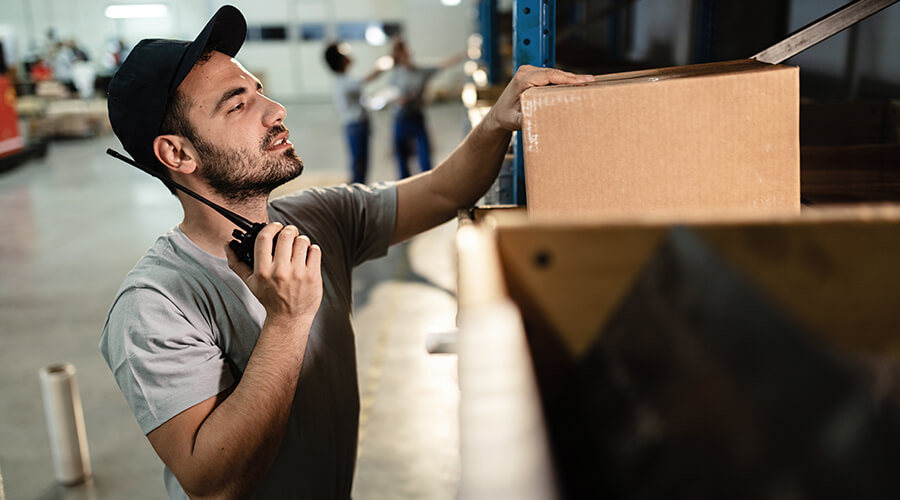 Packing manager checking a box.