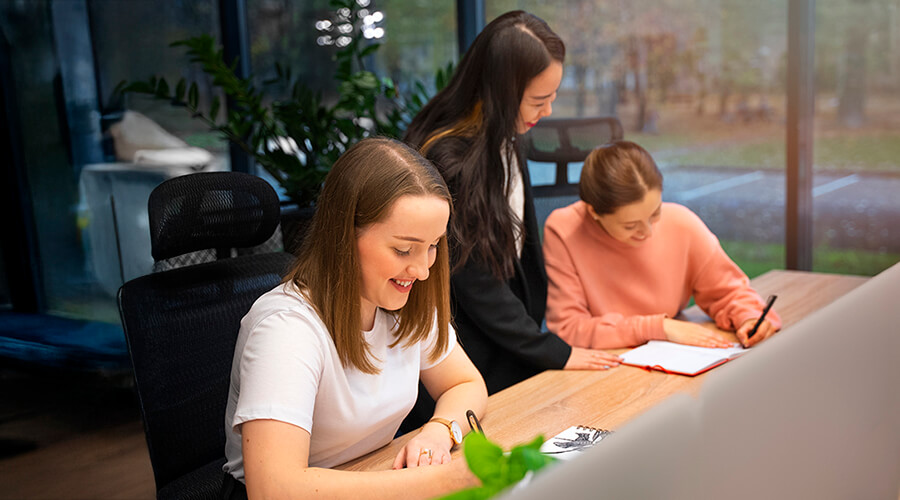 People writing in notebooks.