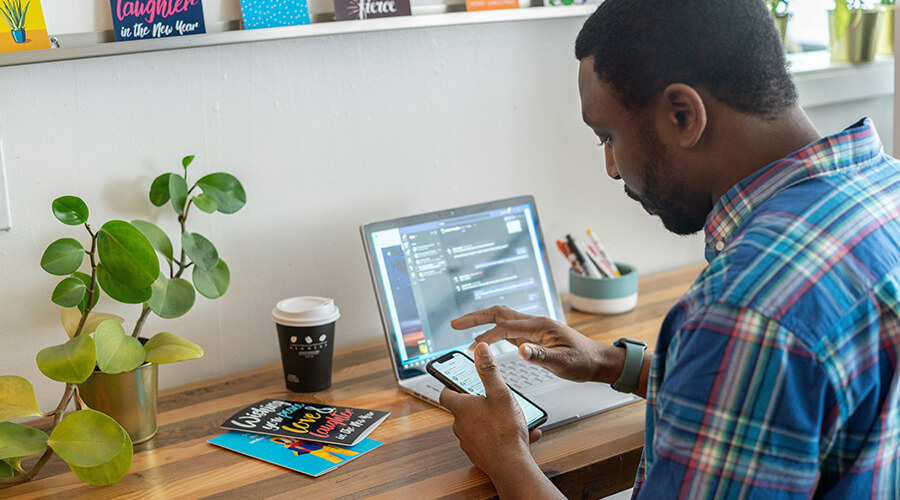 Man using his phone and laptop.