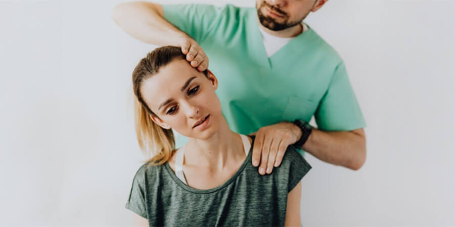 Physiotherapist working on a woman's neck.