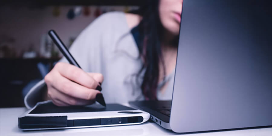 Person writing on a tablet.