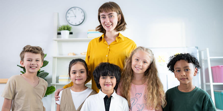 Teaching assistant with a group of young children.