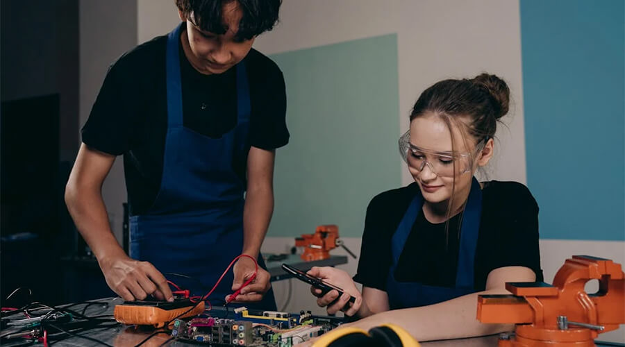 Two technicians testing a motherboard.