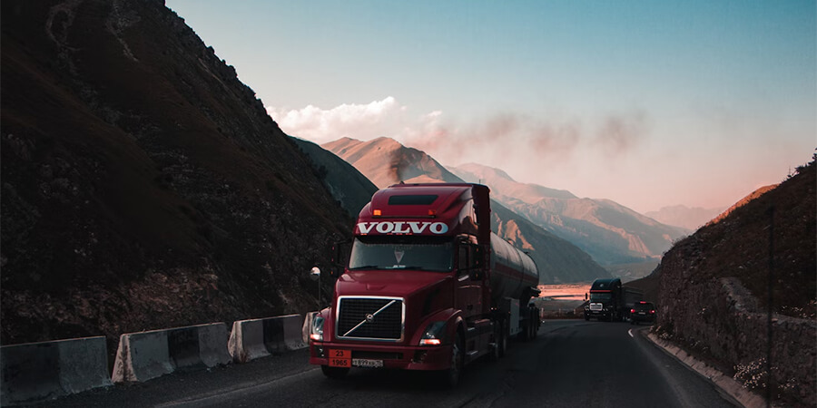 Large Volvo truck driving through the mountains.